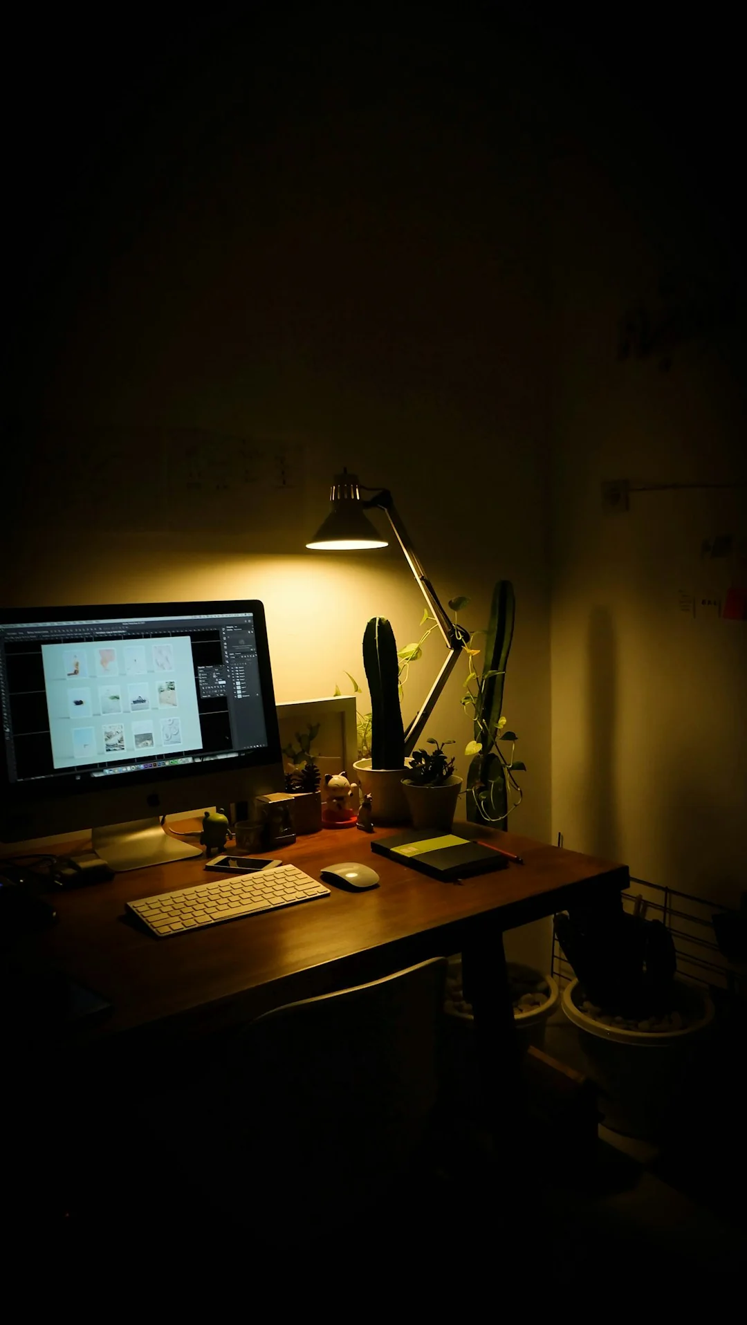 A laptop on a bed showing web design software, creating a cozy workspace.